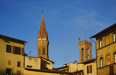 Fototapeta na wymiar Tower of Bargello palace and bell tower of Badia Fiorentina from Signoria square, Florence, Italy