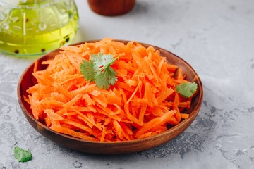 Fresh healthy grated carrot salad in bowl