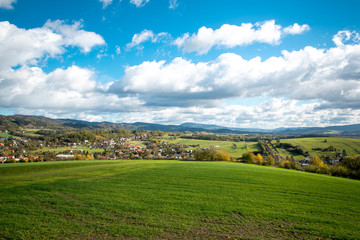 Fototapeta na wymiar A view of the hill and field the surrounding can be seen village during a sunny day with many colored clouds