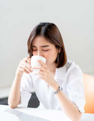 Young woman drink coffee in an office