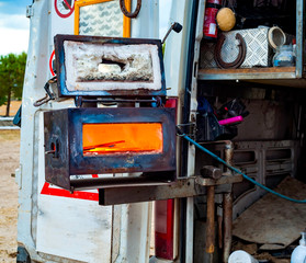 blacksmith's tow truck carrying out home work. In evidence the small electric forge to get the hot...