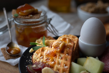 dark moody. breakfast in the village. homemade jam for breakfast. apricot jam with almonds and hazelnuts. fitness breakfast with fresh fruit and crispy heart shaped waffles