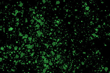Bright green paint splashes on black background Color splash and drop pattern Abstract texture for web-design, digital printing or concept design.