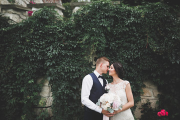 Kissing wedding couple in spring nature close-up portrait