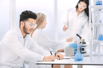 close up.young scientist sitting at his Desk in the laboratory