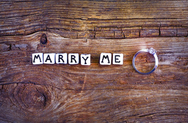 Will you marry me? An offer of marriage on rustic background. Wording 