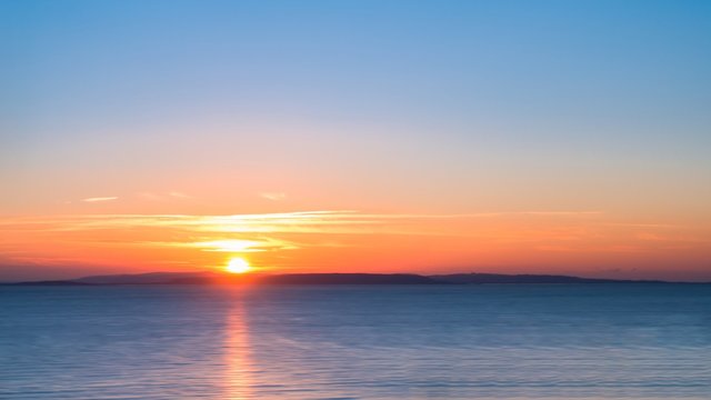 Long Exposure Sunrise over a Blue Sea with Silky Smooth Water © tinasdreamworld