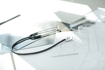 image stethoscope and documents on the table at the surgeon