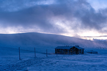 Night view of mountain cabin winter.