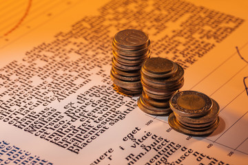 selective focus of coins stacks on business text document