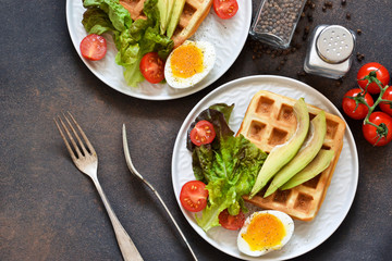 Breakfast time. Waffle with salad, egg plow and avocados for breakfast. View from above.