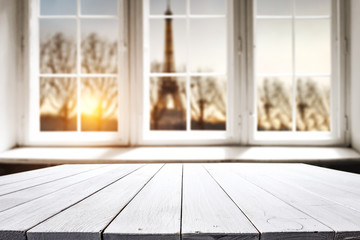 Table background of free space for your decoration. White wooden window space. Sunset time and Paris city landscape. 