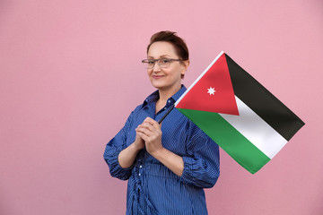 Jordan flag. Woman holding Jordanian flag. Nice portrait of middle aged lady 40 50 years old...