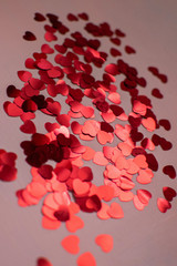 Red hearts. Heart confetti on bright background, glitter background Color of the year 2019 - living coral.