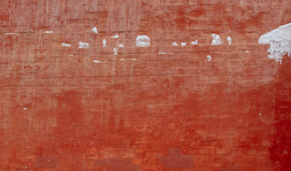 Snow on a red brick wall as background