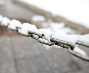Snow on a metal chain as a background