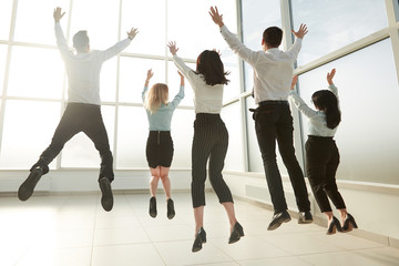 rear view.happy business team, having fun in a bright new office.