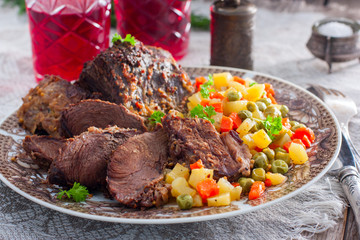 Baked beef with vegetables (carrots, peas, potatoes), horizontal