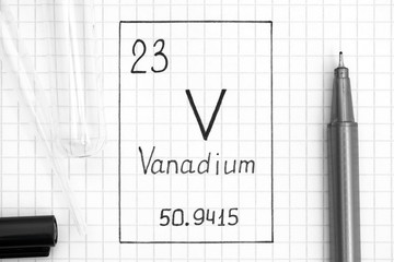 Handwriting chemical element Vanadium V with black pen, test tube and pipette.