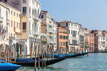 Fototapeta na wymiar Jetty with gondolas on a canal in Venice, Italy