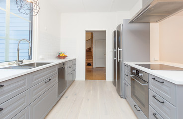 clean kitchen interior with grey cupboards and  kitchen drawers