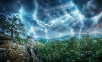 Lightning thunderstorm flash and sun lights in the mountains. Concept on topic weather, cataclysms...