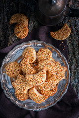 Shortbread cookies with nuts in the forest decor, top view, selective focus