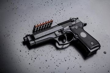 black modern gun on black background. 9mm pistol gun