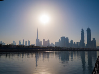 Fototapeta na wymiar Panorama of the city of Dubai early in the morning at sunrise with a bridge over the city channel Dubai Greek.