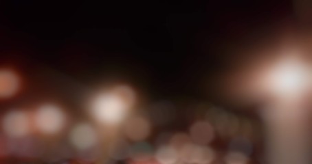 The abstract background of the lights from the lamp on the house fence at night .. lens blurred