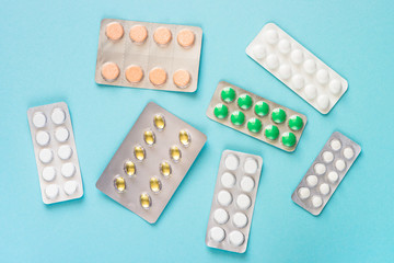 Tablets and vitamin on a blue background.