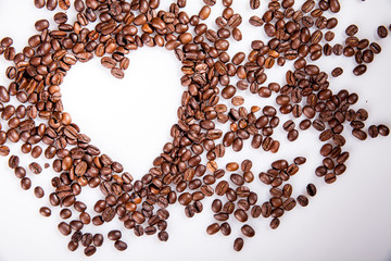 Heart make whit coffee beans and cup whit espresso and sweet heart cookie on wood table background. 