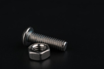 Screw and bolts on black background