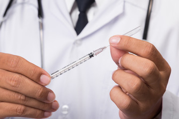 Doctor holding a syringe