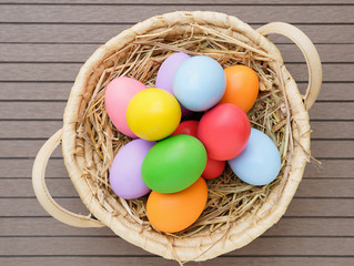 close up Easter eggs in the basket on wood