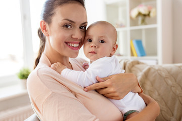 family, motherhood and people concept - happy mother with little baby boy at home
