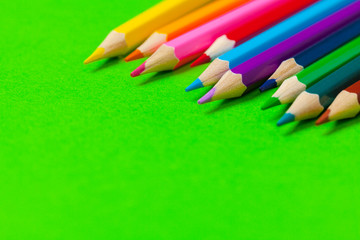 Colored pencils on bright color paper background