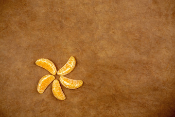 Fototapeta na wymiar slices of mandarin or tangerine with leaves isolated on vintage background.