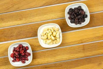 Vegan breakfast: variety of fruits, nuts and berries on the wooden table
