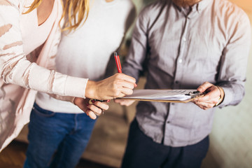Couple signing terms of real-estate contract