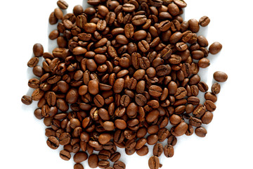 Close-up of roasted coffee beans on white background. View from directly above.