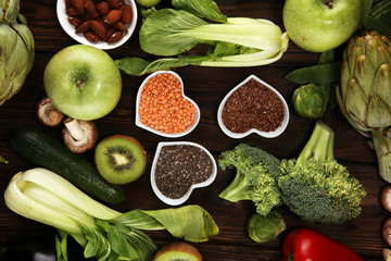Healthy food clean eating selection. fruit, vegetable, seeds, superfood, cereals, leaf vegetable on rustic background