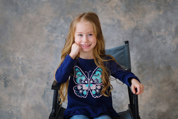 little girl presses a red heart to her chest. Health and Valentine's day concept.