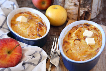 Apple clafoutis in two ceramic dish for sweet breakfast and fresh apples