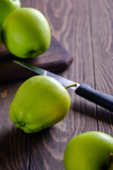 Fresh and juicy green apples on wooden background