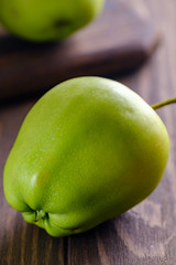 Fresh and juicy green apples on wooden background