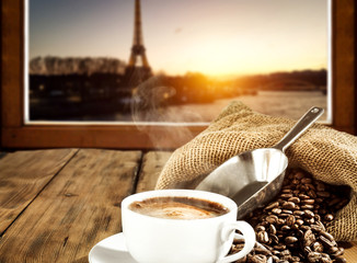 Hot coffee on window sill and Paris landscape 