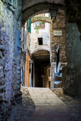 Fototapeta premium Narrow cobbled streets of Italian old town Perinaldo. Medieval Architecture of Liguria, Italy