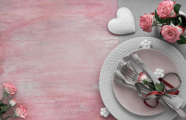 Valentine's day, birthday or anniversary table setup, top view on light pink background, copy-space