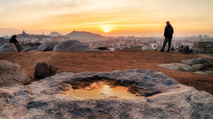 Peoples are watching sunset from ancient fortress wall in Plovdiv city, Bulgaria